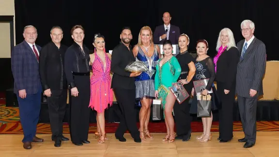Dance Spectacular dancers and judges gathered on the ballroom floor
